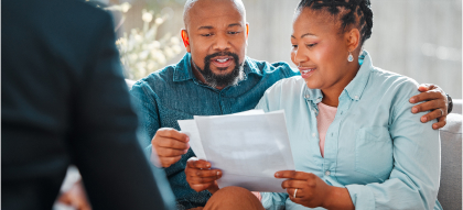 Two people discussing and reading a document together