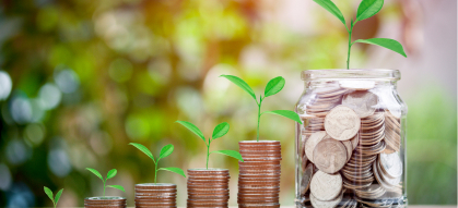 Plants growing out of stacks of coins