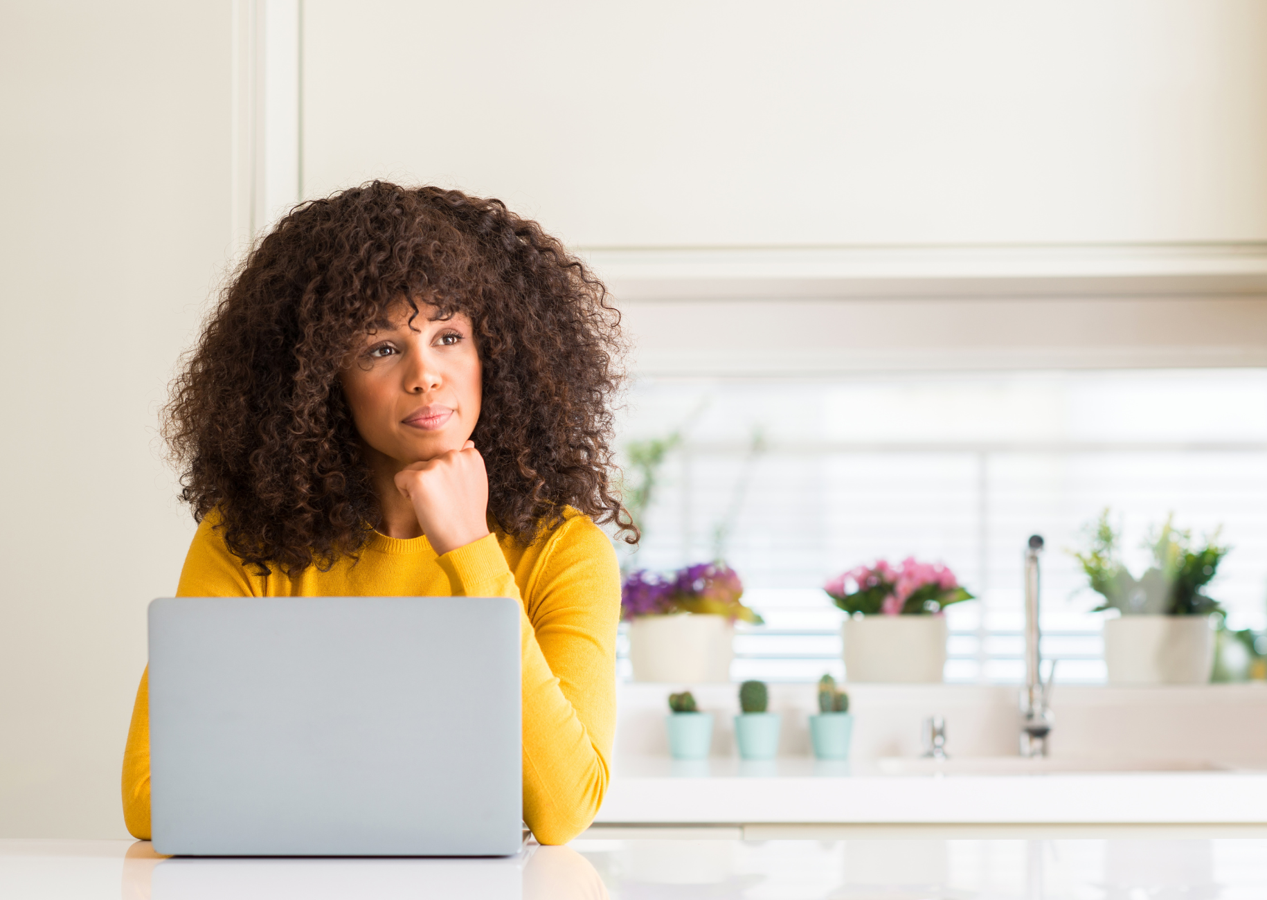 Woman thinking at her computer