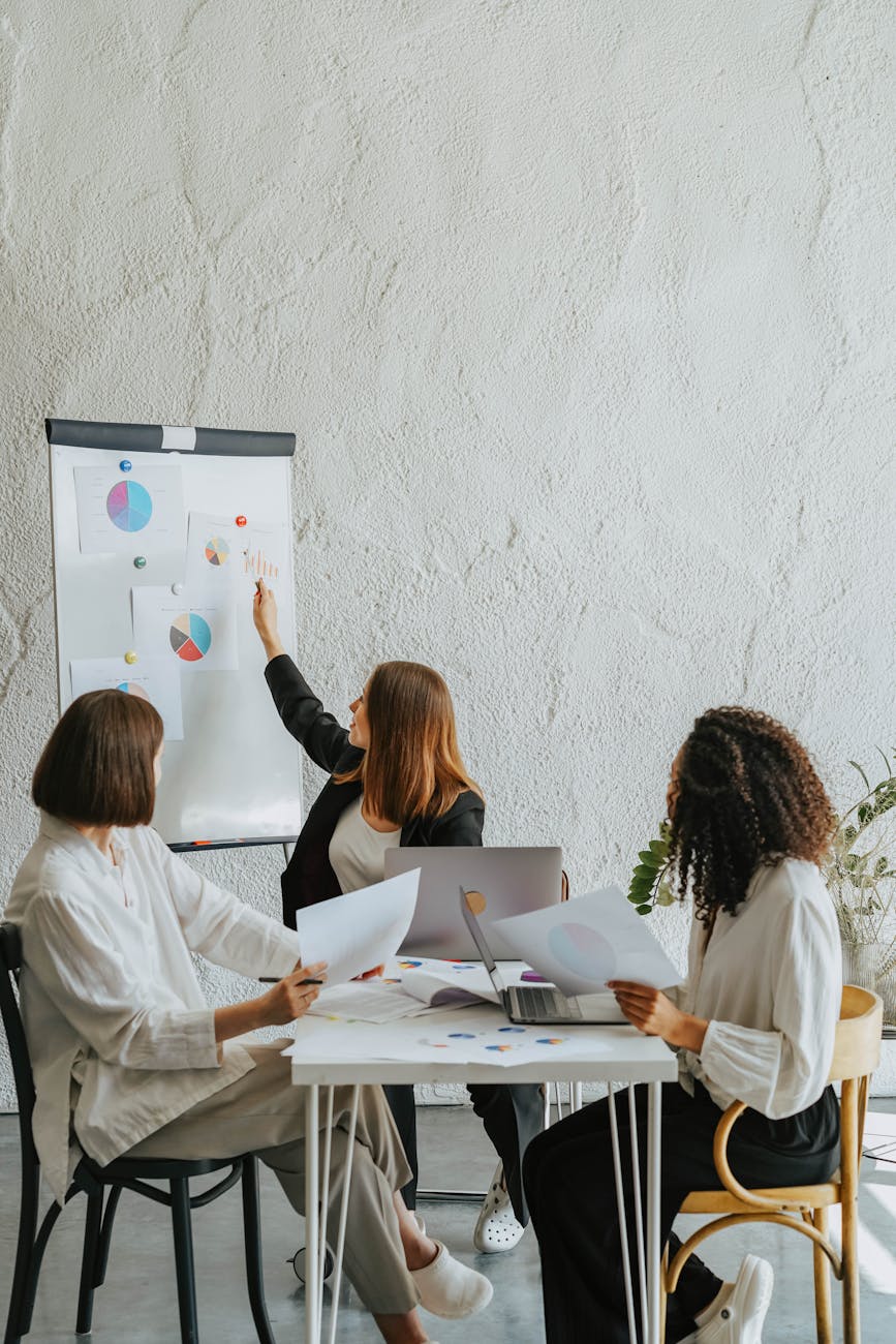 three women discussing and working together